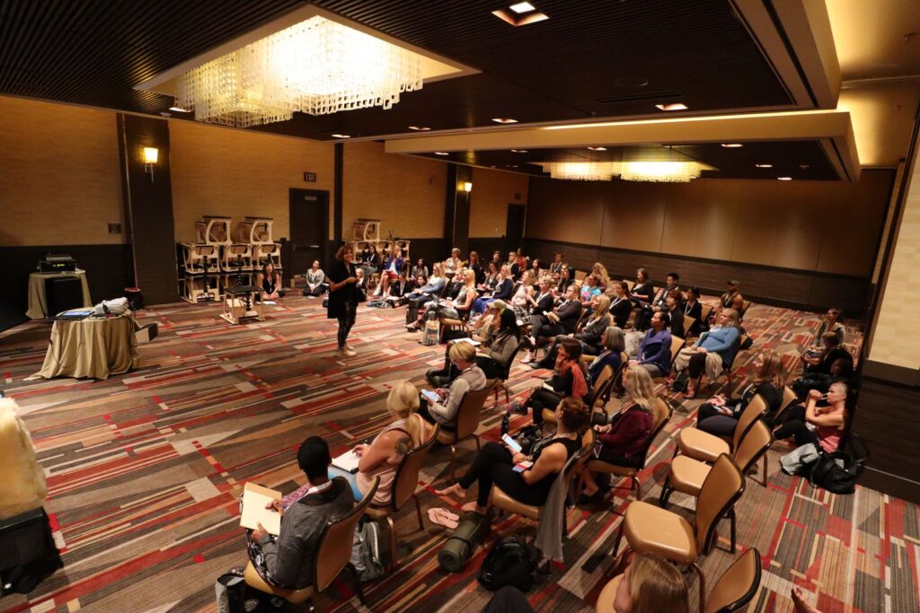 A full conference hall of Pilates instructors at Dr. Hadar Schwartz's workshop, Pilates Method Alliance conference, 2018