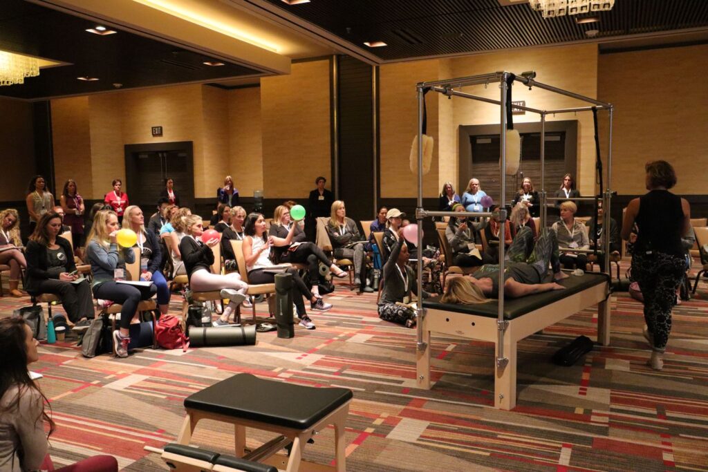 Dr. Hadar Schwartz leading a hands-on breathing workshop on the Cadillac at the Pilates Method Alliance conference, 2018